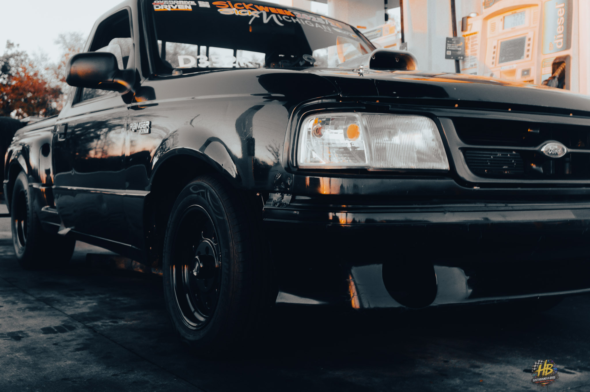 Black Ford truck at fuel stop